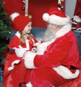 Santa chats with little girl visiting him