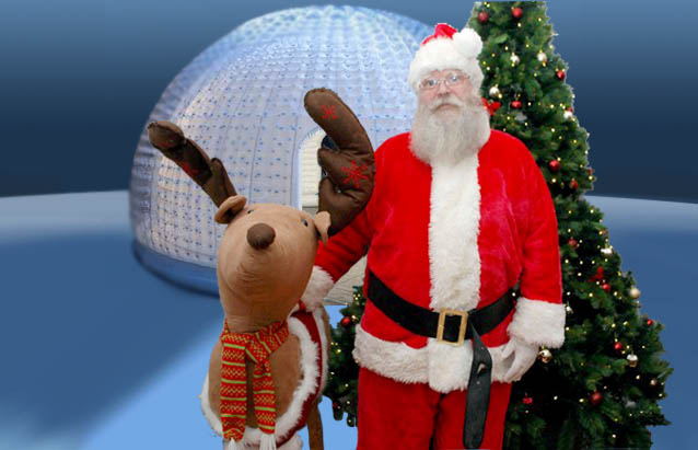 Santa in front of Magical Igloo in landscape