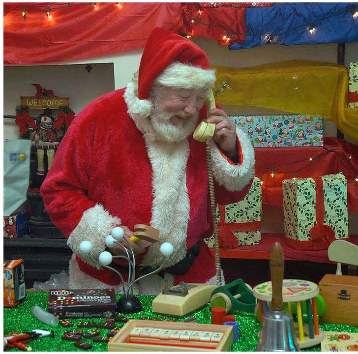Santa on phone in workshop